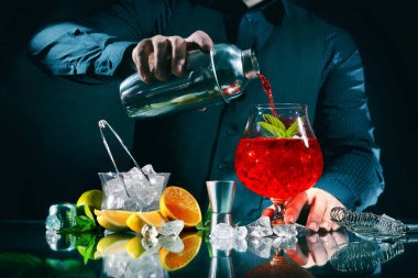 Barmen gece kulübünde Campari portakal kokteyli yapıyor.