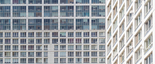 The facade of a modern high-rise building. Front view of many windows. Perfect for urban background and design.
