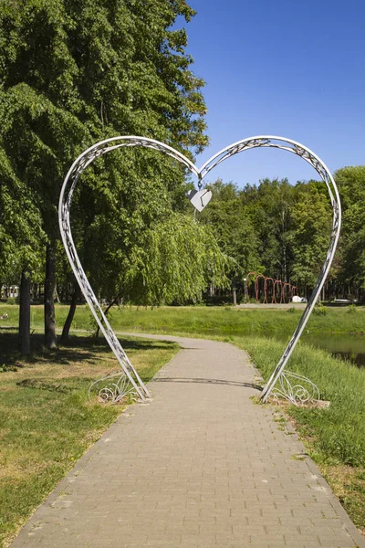 Arch in the shape of a heart on a nature background
