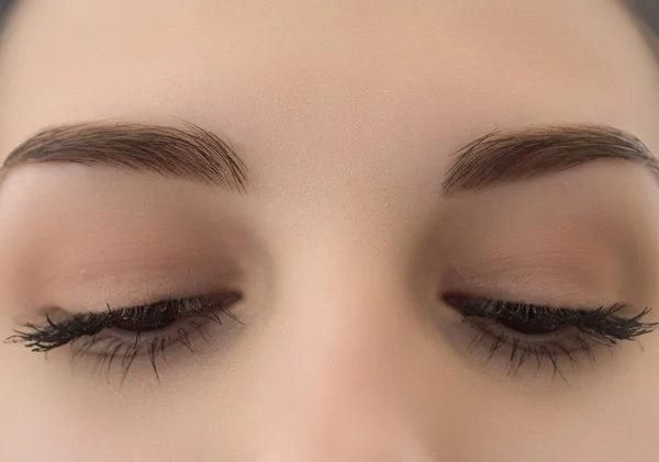 covered female eyes close-up with long eyelashes