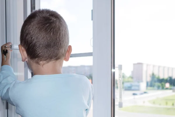 The concept of protecting a child from falling out of a window. The child opens the window close up