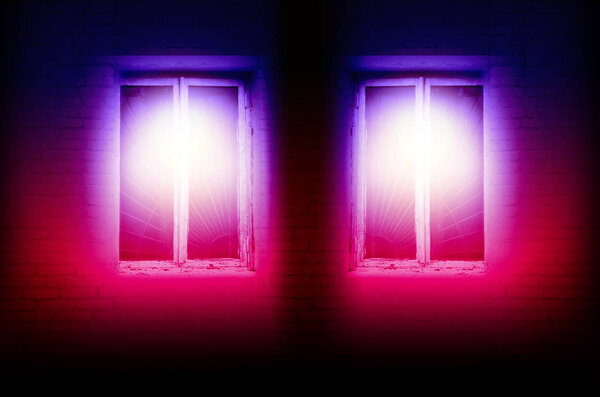 In the old windows in a brick building, a bright neon light burns