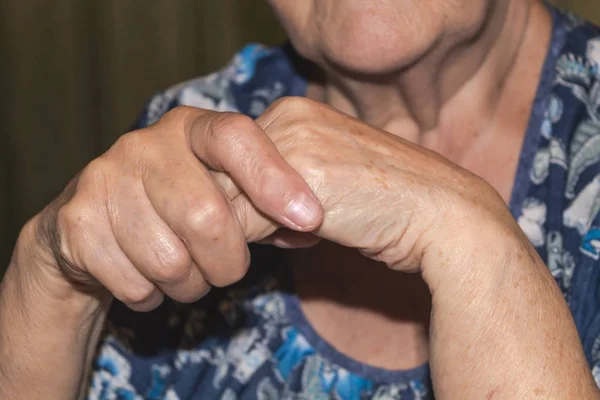 Wrinkled hands of an elderly woman close-up
