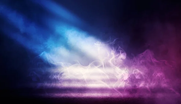 Background of empty dark room with rays of light. Concrete floor with light reflection. Smoke, neon blue light