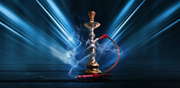 Hookah, smoke on a dark abstract background. Background of empty scenes with neon lights, the reflection of night lights on wet pavement