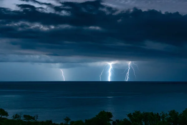 Three lightning over the sea