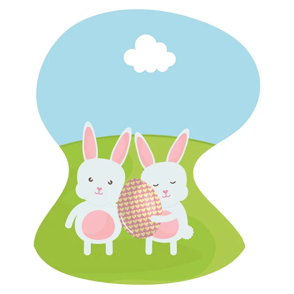 Cute rabbits with easter egg painted in the field — Stock Vector