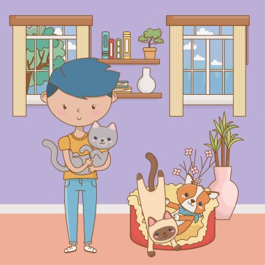 Kedileri ve çizgi film tasarımı olan bir çocuk.