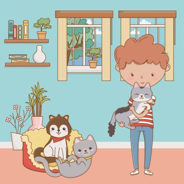 Kedileri ve çizgi film tasarımı olan bir çocuk.