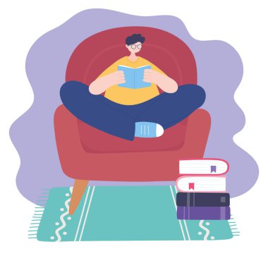 Evde oturup sandalyeyle ilgili kitap okuyan, kendini izole eden, Coronavirus karantinasında faaliyet gösteren adam.