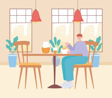 Restoran sosyal mesafesi, masada yemek yiyen genç adam, covid 19 salgını, koronavirüs enfeksiyonunun önlenmesi.