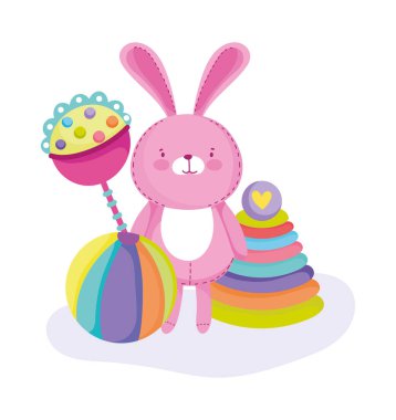 Küçük çocukların çizgi film oynaması için oyuncak. Pembe tavşan çıngırak topu ve piramit.