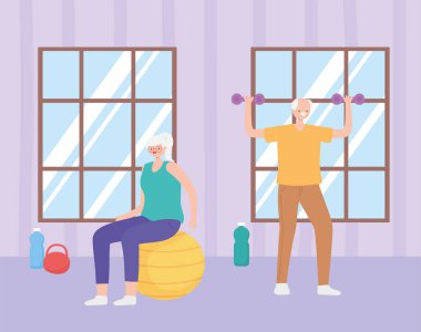 aktivite son sınıfları, yaşlı kadın ve erkek odada ağırlık ve topla alıştırma yapıyor.