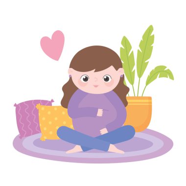 Hamilelik ve hamilelik, tatlı hamile bir kadın halının üzerinde oturmuş karnına dokunuyor.