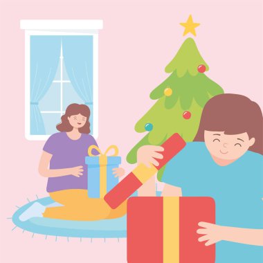 Genç kadınlar hediye kutularını açıyorlar Mutlu noeller kutlamaları