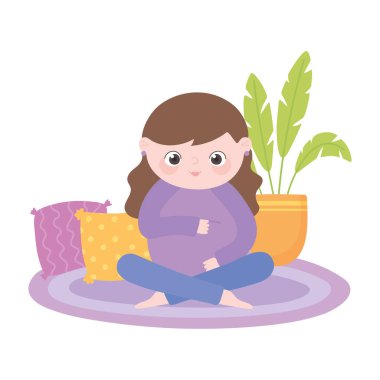 Hamilelik ve hamilelik, tatlı hamile bir kadın halının üzerinde oturmuş karnına dokunuyor.