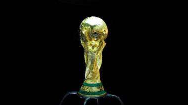 SARAJEVO, BOSNIA AND HERZEGOVINA - MARCH 2014: World Cup Trophy on a black Background, World Cup Trophy, was introduced in 1974. Made of 18 carat gold with a malachite base. clipart
