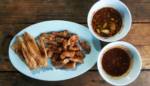 Roasted pork and chilli in plate on table wood — 스톡 사진