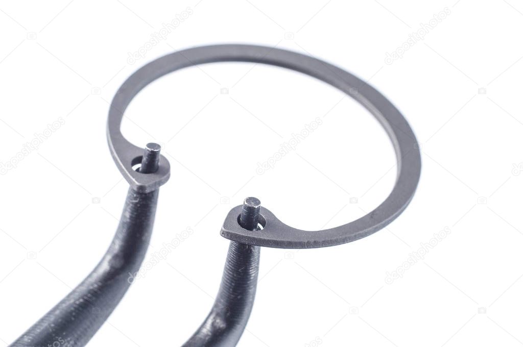 tongs squeeze retaining ring on white background, isolate