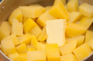 Eriyen bir parça tereyağı ile haşlanmış patates.