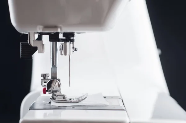 Needle Electromechanical white sewing machine close up on a blac — Stock Photo, Image