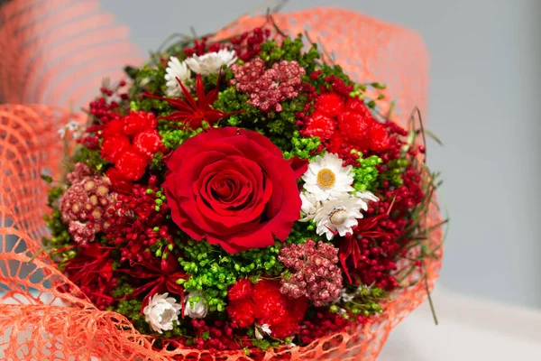 bouquet of dried flowers with red rose on white background
