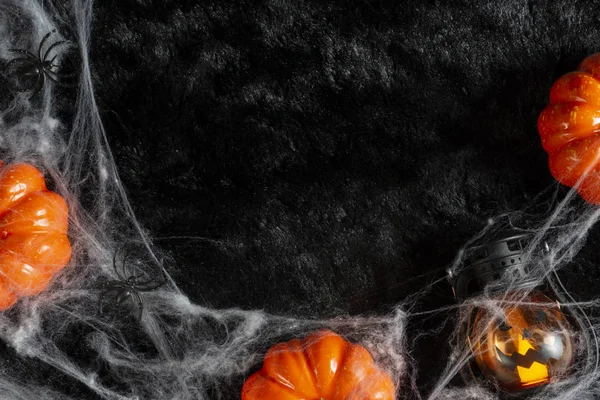 Halloween holiday background concept with a pumpkin, spider web, spider and lantern . — стоковое фото