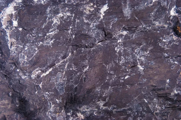 Natural texture of natural black rock with unique pattern and surface texture.
