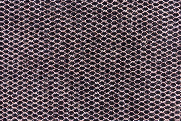 mesh metal diamond pattern on dark background.