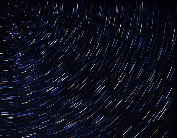 abstract drawing of concentric arcs on a dark background.