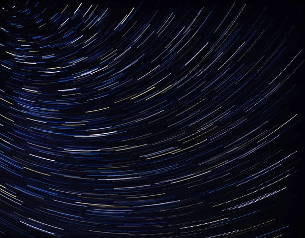 abstract drawing of concentric arcs on a dark background.