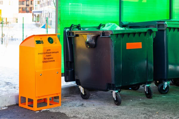 Platform for collecting garbage, a plastic container for garbage, a separate box for the collection of hazardous waste. The inscription on the tank: \'for energy-saving lamps, batteries, thermometers\'