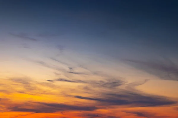 The evening sky with a few clouds at sunset, as a background