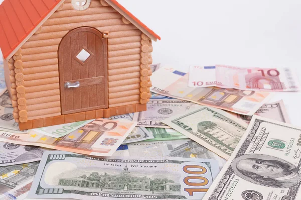 House toy on a pile of banknote — Stock Photo, Image