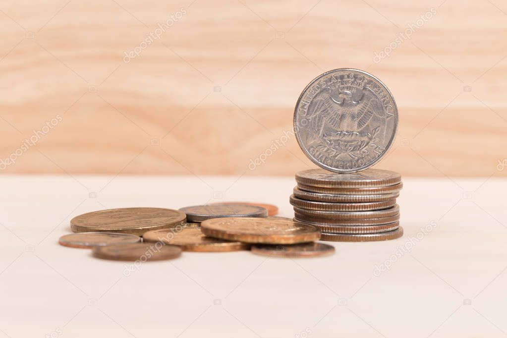 Pile of US coins on wood background