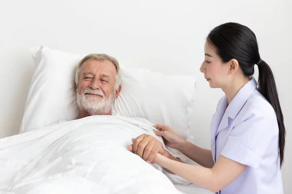 Nurse Cares Elderly Man Lying Bed — Stock Photo, Image