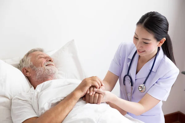 Nurse Cares Elderly Man Lying Bed — Stock Photo, Image