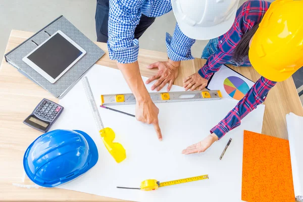 Group of architects woking on blank blueprint