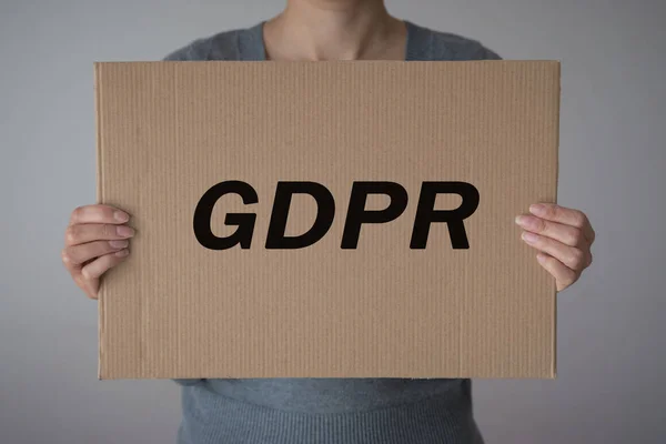 GDPR. A young woman is hidden behind the inscription General Data Protection Regulation. Cyber security and privacy.