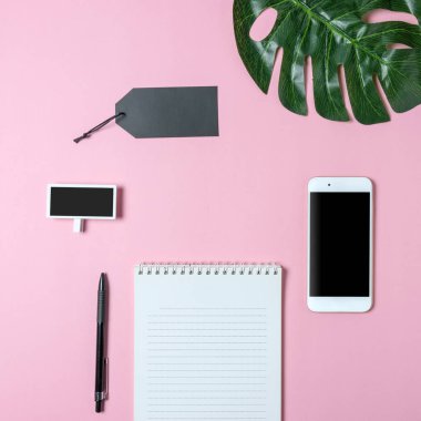 Yaratıcı düz Fotoğraf çalışma masası smartphone, palmiye yaprağı ve defter kopyalama alanı arka plan ile yatırın. En az konsept Sanat.
