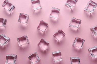 Buz küpleri pastel pembe bir arka plan üzerinde. En az yaz içki kavramı. Düz yatıyordu.
