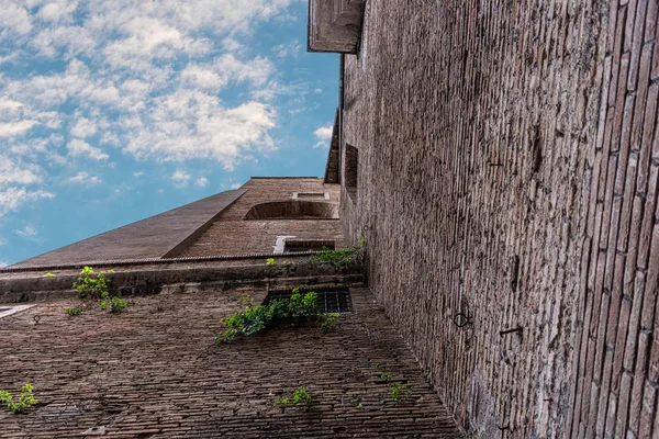 View from below of high castle walls on sky background.