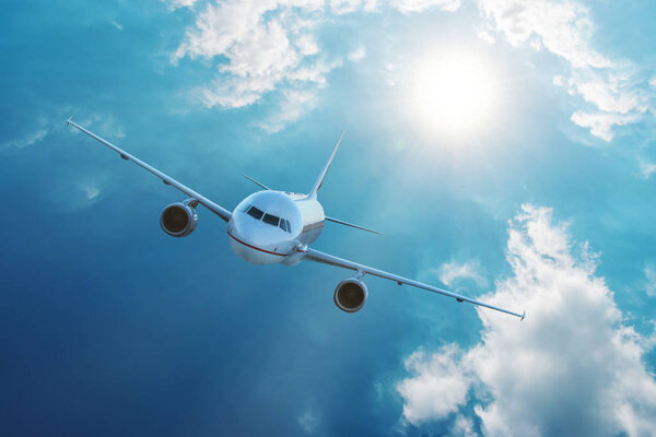 Airplane flying in blue sky with clouds. Travel and transportation concept.