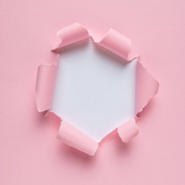 Canlı pembe yırtık kağıt patlama delik arka plan ile. En az soyut kavram.