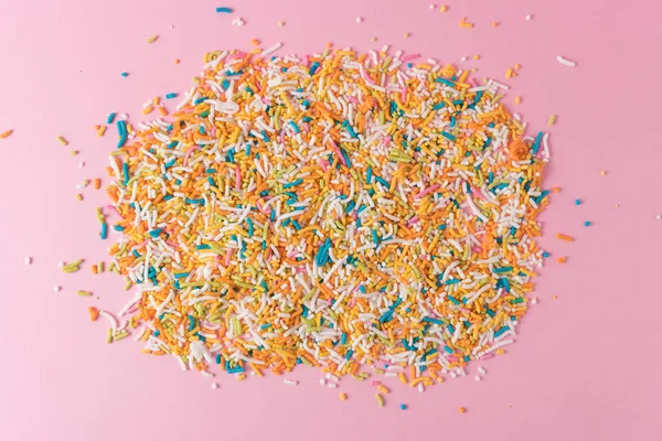 Minimal composition background of colorful sprinkles. Minimal holiday concept.