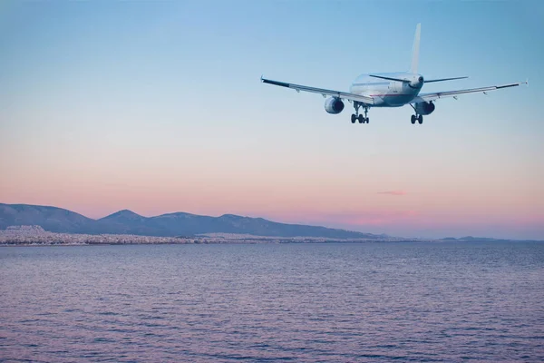 飞机在日落时飞越大海和海滩 旅游理念 — 图库照片