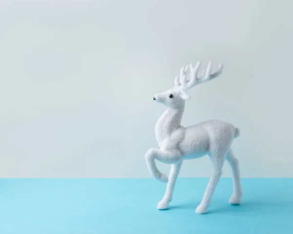 White reindeer on blue background. Christmas or New Year minimal concept. — Stock Photo, Image