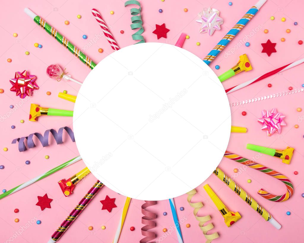 Colorful celebration background with various party confetti, streamers and decoration. Minimal party concept. Flat lay.