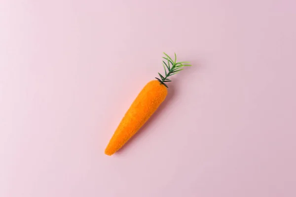 Carrot decoration on pastel pink background. Minimal spring composition. — Stock Photo, Image