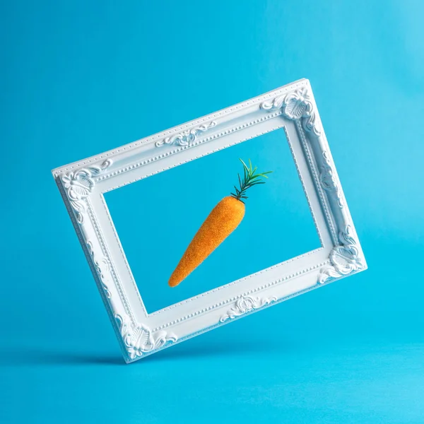 Easter carrot with white vintage frame. Minimal Easter concept. — Stock Photo, Image